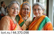Three indian women wearing colorful saris smiling together. Стоковое AI-изображение, AI-художник Юрий Поздников / Фотобанк Лори