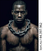 Juneteenth, a day for freedom - African man prisoner in chain slavery concept. Стоковое AI-изображение, AI-художник Veniamin Kraskov / Фотобанк Лори