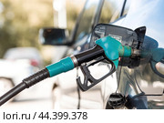 The gas station. Filling the car with gasoline. A Russian fuel dispenser in the fuel tank of a car at a gas station. Rising fuel prices around the world. (2024 год). Стоковое фото, фотограф Photojuli / Фотобанк Лори