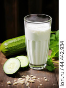 Glass of milk with fresh cucumber. Стоковое AI-изображение, AI-художник Veniamin Kraskov / Фотобанк Лори