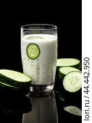 Glass of milk with fresh cucumber. Стоковое AI-изображение, AI-художник Veniamin Kraskov / Фотобанк Лори