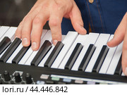 Hands on synthesizer and piano keys. Стоковое фото, фотограф Evgenii Predibailo / Фотобанк Лори
