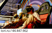 Children in virtual reality helmets in a 5D attraction. Стоковое фото, фотограф Igor Skripachev / Фотобанк Лори