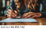 A person writes a formal document at a wooden desk during the day, focusing on the task with a pen in hand and papers laid out. Стоковое AI-изображение, AI-художник Сергей Толмачёв / Фотобанк Лори