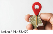Holding a red map pin and key on a green map, symbolizing location and access in urban exploration, captured against a plain background. Стоковое AI-изображение, AI-художник Сергей Толмачёв / Фотобанк Лори