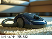 Modern vacuum cleaner on a carpeted floor. Стоковое AI-изображение, AI-художник Иван Рябоконь / Фотобанк Лори