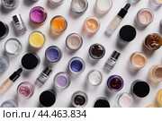 Assortment of colorful cosmetic jars on white background. Стоковое AI-изображение, AI-художник Иван Рябоконь / Фотобанк Лори