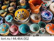 Assorted colorful ceramic pottery collection. Стоковое AI-изображение, AI-художник Иван Рябоконь / Фотобанк Лори