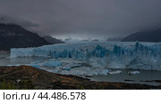 The incredible Perito Moreno glacier stretches between the mountains to the horizon. An endless field of blue ice with cracks, sharp peaks. Thawed ice floes, icebergs float in a turquoise glacial lake. Стоковое фото, фотограф Вера Ивановна Кубарева / Фотобанк Лори