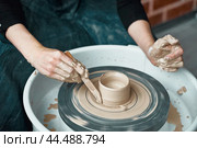 Woman making ceramic pottery on wheel, hands close-up, creation of ceramic ware. Стоковое фото, фотограф Natalia Gdovskaia / Фотобанк Лори