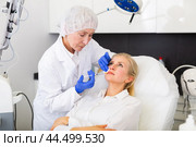 Cosmetologist doing botulotoxin injections for young woman. Стоковое фото, фотограф Яков Филимонов / Фотобанк Лори
