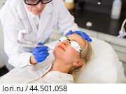 Female client receiving face skin laser resurfacing at cosmetology clinic. Стоковое фото, фотограф Яков Филимонов / Фотобанк Лори