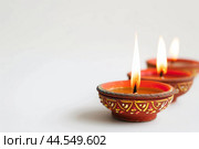 Traditional diya lamps alight for diwali celebration. Стоковое AI-изображение, AI-художник Иван Рябоконь / Фотобанк Лори