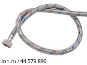Сантехнический шланг в металлической оплетке для воды на белом фоне. Plumbing hose in a metal braid for water. Стоковое фото, фотограф Татьяна Д / Фотобанк Лори