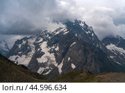 View of the Great Caucasian Ridge opening from the Upper station of the cable car system of the Dombay ski resort on a summer day, Karachay-Cherkessia, Russia. Стоковое фото, фотограф Ula Ulachka / Фотобанк Лори