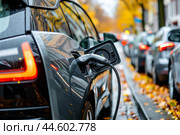 Electric car charging at urban station. Стоковое AI-изображение, AI-художник Иван Рябоконь / Фотобанк Лори