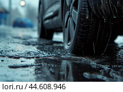 Wet car tire on rainy street. Стоковое AI-изображение, AI-художник Иван Рябоконь / Фотобанк Лори