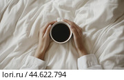 Cozy mornings with a warm cup of coffee in bed, embracing tranquility and comfort in a serene atmosphere. Стоковое AI-изображение, AI-художник Сергей Толмачёв / Фотобанк Лори
