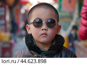 Cool young boy with sunglasses. Стоковое AI-изображение, AI-художник Иван Рябоконь / Фотобанк Лори