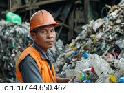 Worker sorting recyclables at waste management facility. Стоковое AI-изображение, AI-художник Иван Рябоконь / Фотобанк Лори