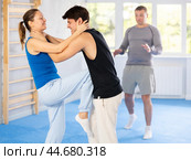 Guy and woman train to perform defense of strangling opponent, while learning self-defense. Стоковое фото, фотограф Яков Филимонов / Фотобанк Лори