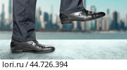 Man takes step in classic shoes. Motivation and challenging. Close up legs of businessman walking stepping up stair in modern city, business growth, go up, success, grow up business concept. Стоковое фото, фотограф Павел Муравьев / Фотобанк Лори