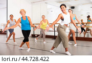 Group of active women practicing energetic dance in a studio. Стоковое фото, фотограф Яков Филимонов / Фотобанк Лори