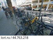 Cologne, Germany -  June 25, 2019: Photography of the cars parking and bikes parking on the city street in hot summer day. Theme of heat touristic time in the city. Редакционное фото, фотограф YuryKara / Фотобанк Лори