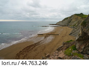 Charming Zumaia Itzurun beach. Steeply-tilted layers of flysch in Zumaia. Atlantic ocean surf in Basque Autonomous Community  in day in Bay of Biscay. View from above / top view. Стоковое фото, фотограф YuryKara / Фотобанк Лори