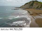 Charming Zumaia Itzurun beach. Steeply-tilted layers of flysch in Zumaia. Atlantic ocean surf in Basque Autonomous Community  in day in Bay of Biscay. View from above / top view. Стоковое фото, фотограф YuryKara / Фотобанк Лори
