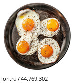 Four fried eggs with black pepper cooking in a pan. Стоковое AI-изображение, AI-художник Иван Рябоконь / Фотобанк Лори