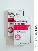Covid-19 Antigen Self Test kit box on table. Rapid nasal test. Редакционное фото, фотограф Константин Григорьев / Фотобанк Лори
