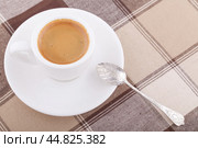 Кофейный натюрморт: белая чашка с кофе, мельхиоровая ложка на клетчатой скатерти. Стоковое фото, фотограф Александр Рыбалка / Фотобанк Лори