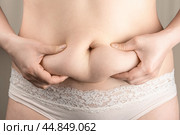 Excessive belly fat, overweight concept. woman with fat belly, overweight female body, concept of dieting, losing weight. Стоковое фото, фотограф Павел Муравьев / Фотобанк Лори