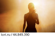 Successful, strong woman overcomes difficulties and runs towards her goals and achievements. Female silhouette on sunrise city background. Success Business Leadership. Стоковое фото, фотограф Павел Муравьев / Фотобанк Лори