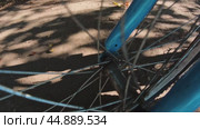 The front wheel of a bicycle and its shadow while driving on a sunny day. Стоковое видео, видеограф Ярославский Максим / Фотобанк Лори