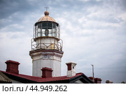 There exists a lighthouse that features a t atop it, which stands out distinctly. Редакционное фото, фотограф Victor Kaprov / Фотобанк Лори