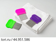 Anti lice combs and towel on white background. Стоковое фото, фотограф Сергей Толмачёв / Фотобанк Лори