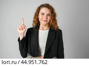 Young Woman in Black Jacket Pointing Up. Стоковое фото, фотограф Сергей Толмачёв / Фотобанк Лори