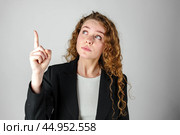 Young Woman in Black Jacket Pointing Up. Стоковое фото, фотограф Сергей Толмачёв / Фотобанк Лори