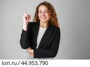 Young Woman in Black Jacket Pointing Up. Стоковое фото, фотограф Сергей Толмачёв / Фотобанк Лори