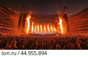 Rock band performing live on stage with pyrotechnics and fans cheering. Стоковое AI-изображение, AI-художник Юрий Поздников / Фотобанк Лори