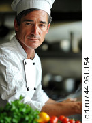 An attractive male chef, showcasing his culinary mastery and charisma. Редакционное AI-изображение, AI-художник Veniamin Kraskov / Фотобанк Лори