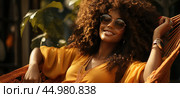Sensual young woman шт sunglasses enjoying her vacation with curls decorative earrings and a necklace lies basking in hammock. Стоковое AI-изображение, AI-художник Данила Большаков / Фотобанк Лори