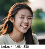 A cheerful Chinese girl stands outdoors, showcasing her radiant smile against a backdrop of lush trees and a lively park atmosphere, capturing the warmth of a sunny day. Mongoloid Asian face type. AI. Стоковое AI-изображение, AI-художник Юлия Петровская / Фотобанк Лори