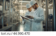 Professionals in lab coats conducting quality checks in a pharmaceutical manufacturing facility during daylight hours. Стоковое AI-изображение, AI-художник Сергей Толмачёв / Фотобанк Лори