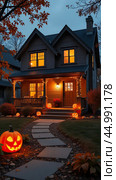 Halloween glowing decor on the facade of the house outside made of pumpkins, garlands, Jack Latern, candles. Halloween party In the evening at dusk. AI generated. Стоковое AI-изображение, AI-художник Ольга Симонова / Фотобанк Лори
