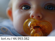 Baby with a pacifier in its mouth. Стоковое AI-изображение, AI-художник Иван Рябоконь / Фотобанк Лори
