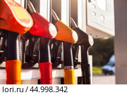 Colorful filling pistols close-up of fuel pump petrol station urban street outdoors. Fuel gasoline dispenser in city filling gas station, poster. Autogas station background concept. Copy ad text space. Стоковое фото, фотограф Aleksandr Golubev / Фотобанк Лори