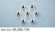 Linking entities, Hierarchy and HR. Wooden blocks connected together on a blue background. Teamwork concept. Wooden blocks connected together on a blue background. Teamwork concept. Стоковое фото, фотограф Павел Муравьев / Фотобанк Лори